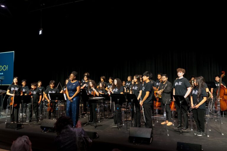 The People's Music School Cross-Site Ensemble, directed by Natalie Butler, after performing "Let's Get Loud